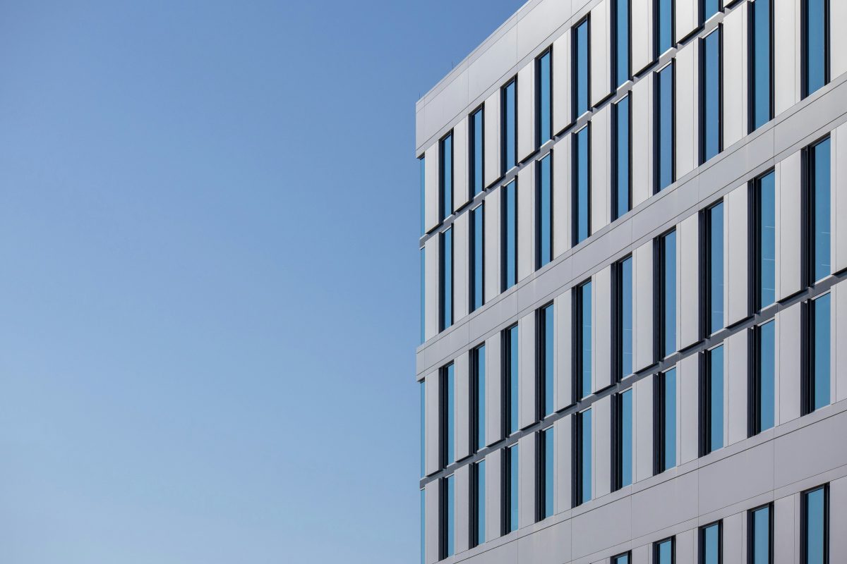 Modern commercial office building exterior showing glass facade and energy efficient design features